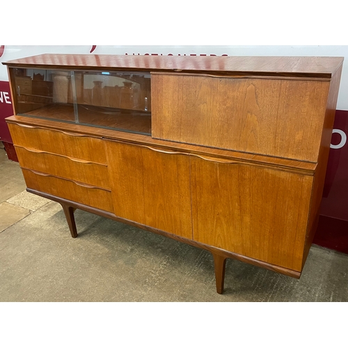 33 - A teak highboard