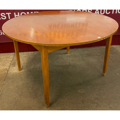 37 - A teak circular extending dining table