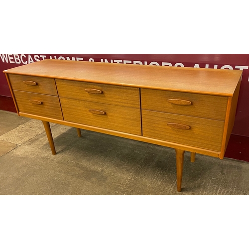 40 - An Austin Suite teak six drawer sideboard