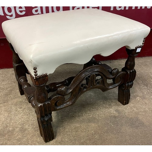 84 - A Victorian carved oak and white vinyl upholstered footstool