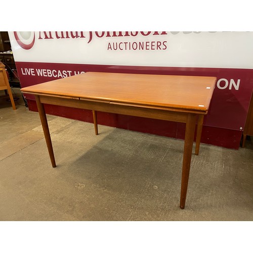 47 - A Danish teak draw-leaf dining table