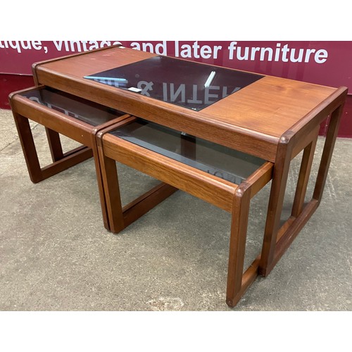 46 - A teak and smoked glass topped nest of tables