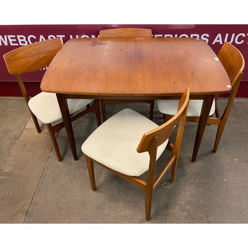 55 - A teak extending dining table and four chairs