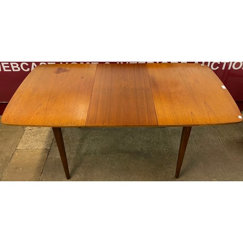 55 - A teak extending dining table and four chairs