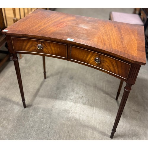 133 - A Regency style mahogany two drawer concave side table