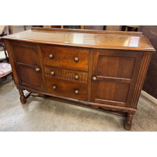 135 - An early 20th Century carved oak sideboard