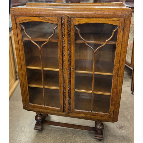 141 - An early 20th Century carved oak two door bookcase