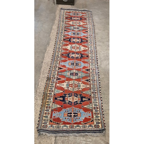 168 - Two Eastern hand knotted woollen runner rugs, 87 x 324cms and 69 x 292cms