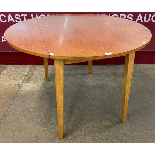 67 - A teak drop leaf dining table