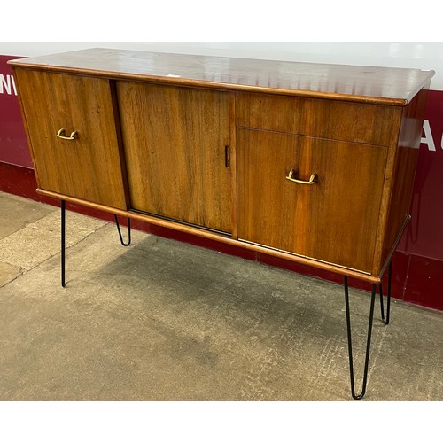 76 - An afromosia sliding door sideboard, on hairpin legs