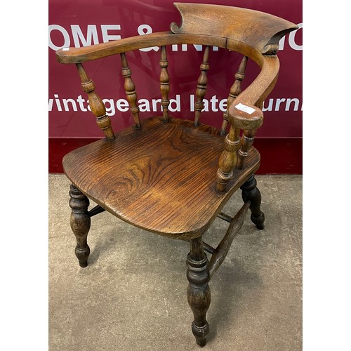 95 - A Victorian elm and beech smokers bow elbow chair