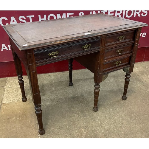 97 - A Victorian Aesthetic Movement mahogany and tan leather topped kneehole desk