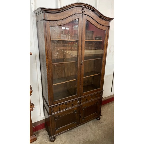 102 - An early 20th Century Jacobean Revival oak geometric moulded bookcase