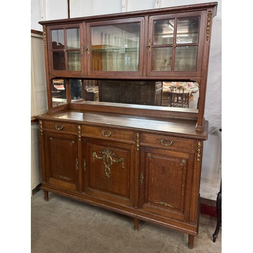 192 - An early 20th Century French oak and gilt metal mounted mirrorback dresser