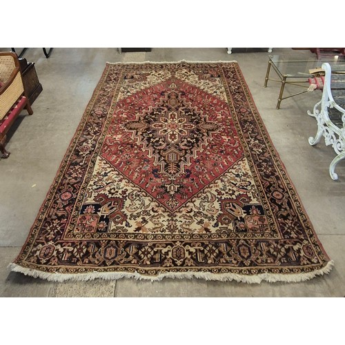 169 - A large Keshan terracotta ground rug, 204 x 301cms