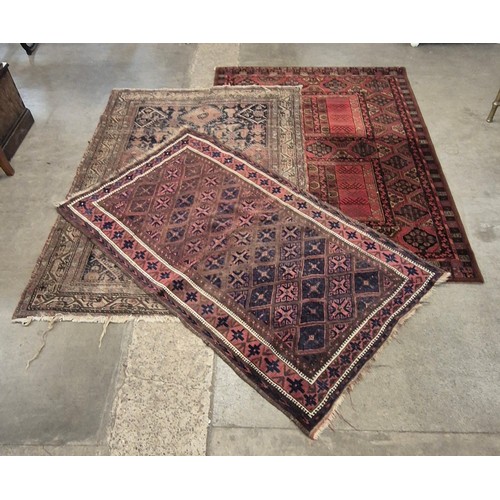 170 - Two Eastern hand knotted rugs and one other, 102 x 178cms, 135 x 195cms and 141 x 202cms