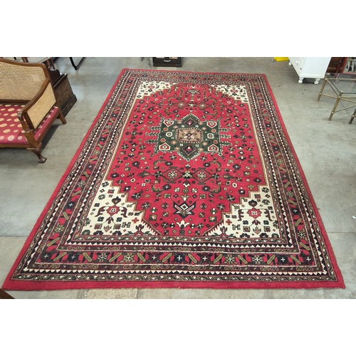 171 - A large Keshan red ground rug, 250 x 346cms