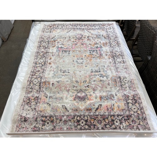 3129 - An ivory ground, full pile, vintage look rug with traditional design