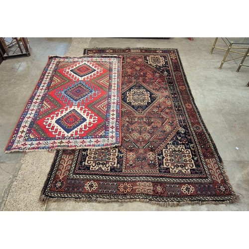 175 - Two Eastern hand knotted terracotta woollen rugs, 172 x 272cms and 120 x 180cms