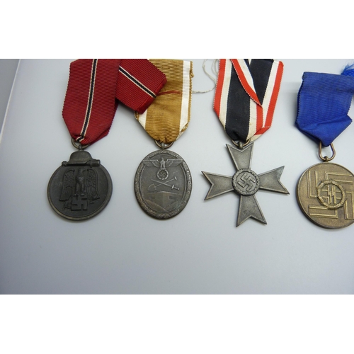 2039 - A collection of five German WWII medallions, West Wall medal, two SS Long Service Awards including 8... 