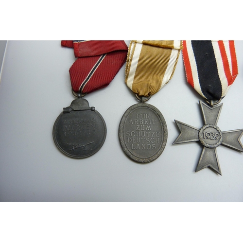 2039 - A collection of five German WWII medallions, West Wall medal, two SS Long Service Awards including 8... 