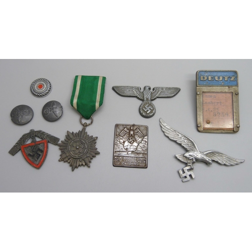 2049 - German WWII related items including two eagle plaques, a medallion, etc., (three buttons a/f)