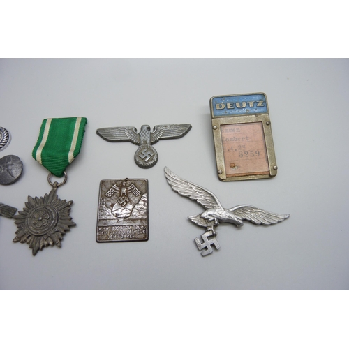 2049 - German WWII related items including two eagle plaques, a medallion, etc., (three buttons a/f)