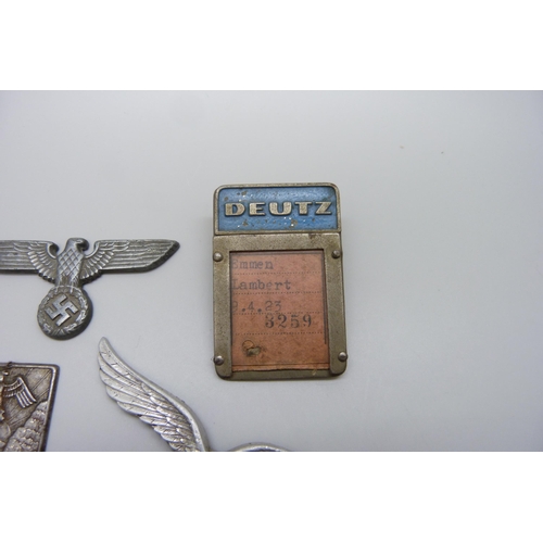 2049 - German WWII related items including two eagle plaques, a medallion, etc., (three buttons a/f)