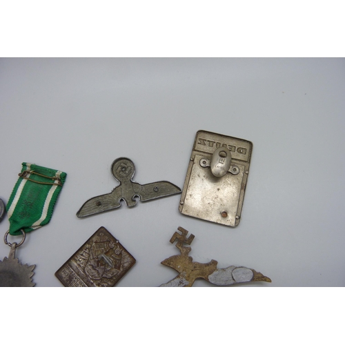 2049 - German WWII related items including two eagle plaques, a medallion, etc., (three buttons a/f)