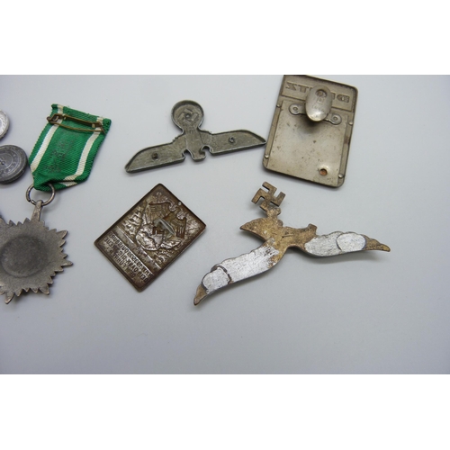 2049 - German WWII related items including two eagle plaques, a medallion, etc., (three buttons a/f)