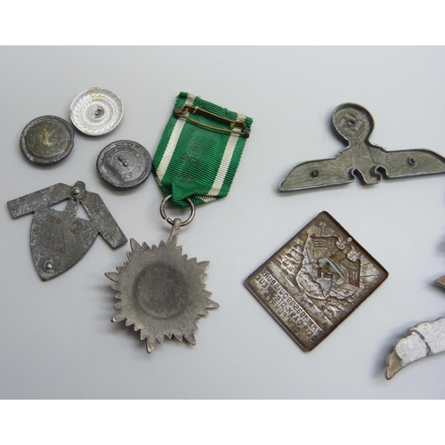 2049 - German WWII related items including two eagle plaques, a medallion, etc., (three buttons a/f)