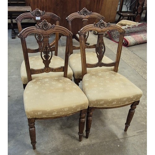 176 - A set of four Victorian carved walnut dining chairs