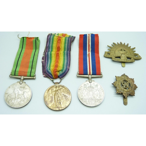 2074 - A WWI Victory medal to 89061 Gnr. H.E. Grudglings R.A., two WWII medals and two badges