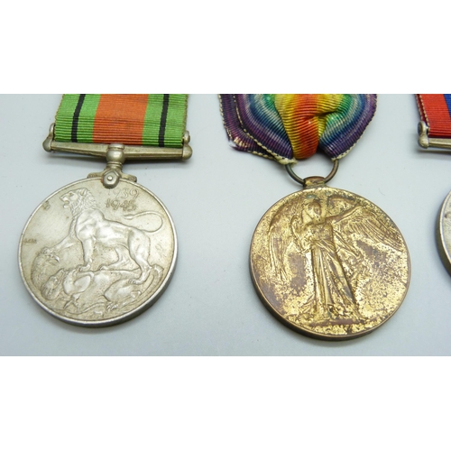 2074 - A WWI Victory medal to 89061 Gnr. H.E. Grudglings R.A., two WWII medals and two badges