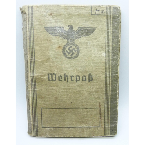 2079 - A German WWII soldiers army handbook, with many entries and stamps throughout the duration of the wa... 