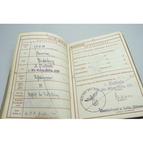 2079 - A German WWII soldiers army handbook, with many entries and stamps throughout the duration of the wa... 