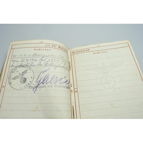 2079 - A German WWII soldiers army handbook, with many entries and stamps throughout the duration of the wa... 