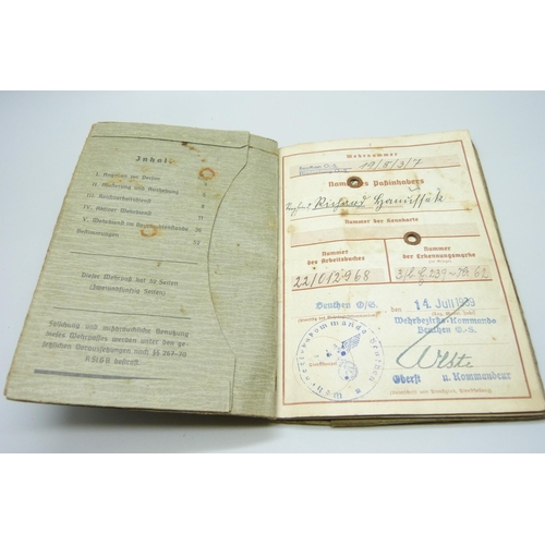 2079 - A German WWII soldiers army handbook, with many entries and stamps throughout the duration of the wa... 
