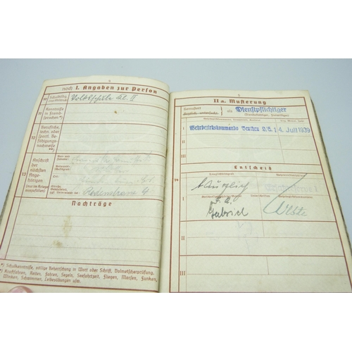 2079 - A German WWII soldiers army handbook, with many entries and stamps throughout the duration of the wa... 
