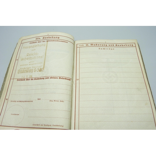 2079 - A German WWII soldiers army handbook, with many entries and stamps throughout the duration of the wa... 