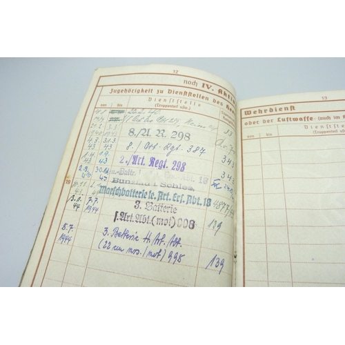 2079 - A German WWII soldiers army handbook, with many entries and stamps throughout the duration of the wa... 