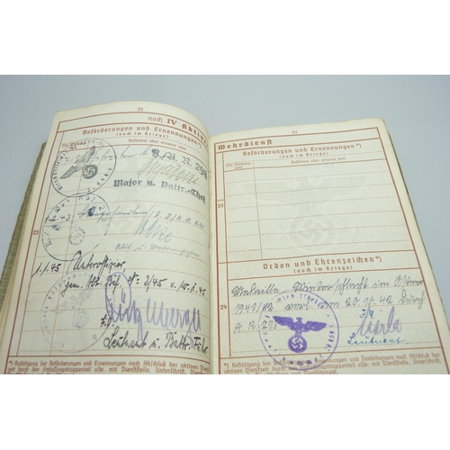 2079 - A German WWII soldiers army handbook, with many entries and stamps throughout the duration of the wa... 