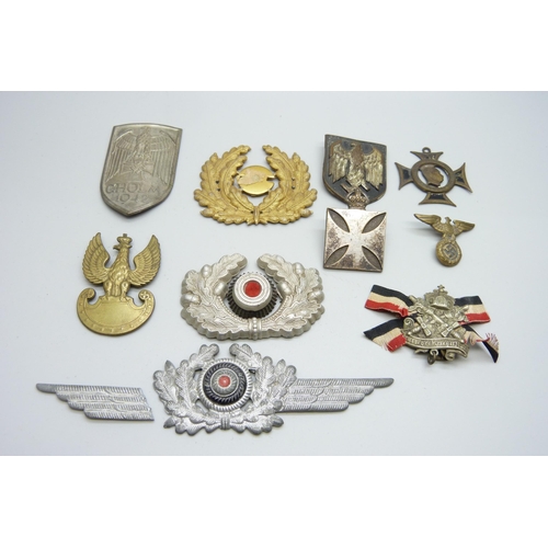 2081 - A collection of badges, etc., including a German WWII pith helmet eagle shield, a German army visor ... 