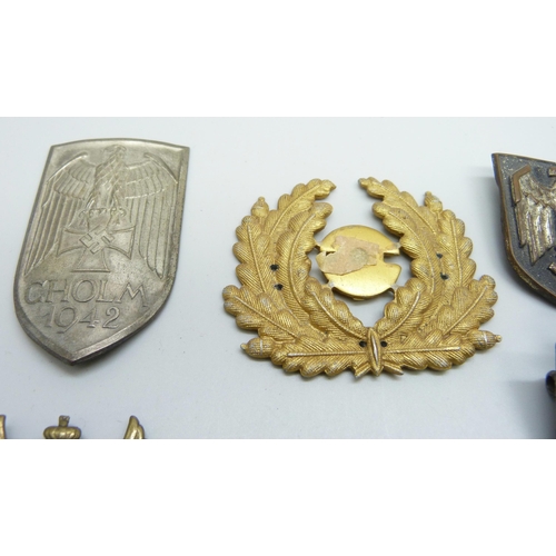 2081 - A collection of badges, etc., including a German WWII pith helmet eagle shield, a German army visor ... 