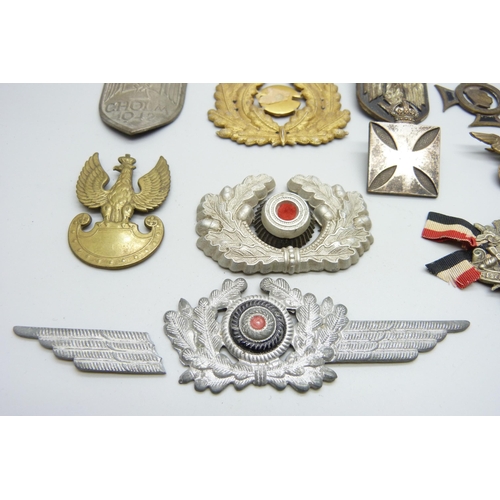 2081 - A collection of badges, etc., including a German WWII pith helmet eagle shield, a German army visor ... 