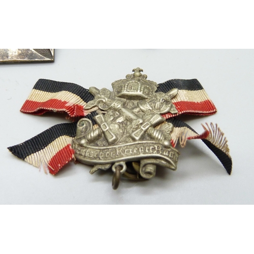 2081 - A collection of badges, etc., including a German WWII pith helmet eagle shield, a German army visor ... 