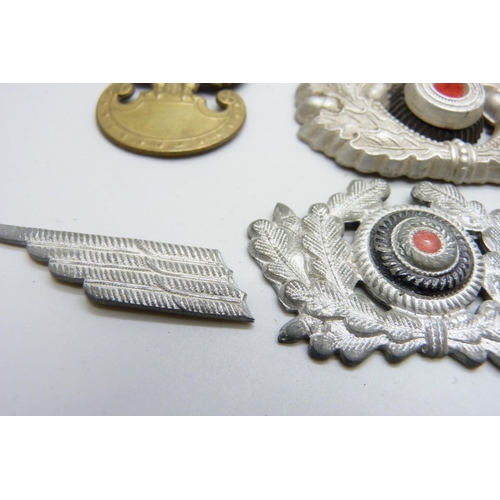 2081 - A collection of badges, etc., including a German WWII pith helmet eagle shield, a German army visor ... 