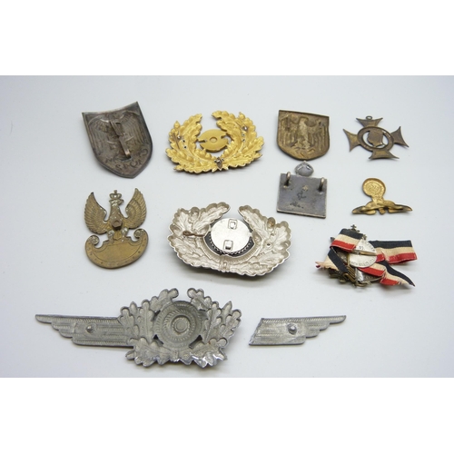 2081 - A collection of badges, etc., including a German WWII pith helmet eagle shield, a German army visor ... 