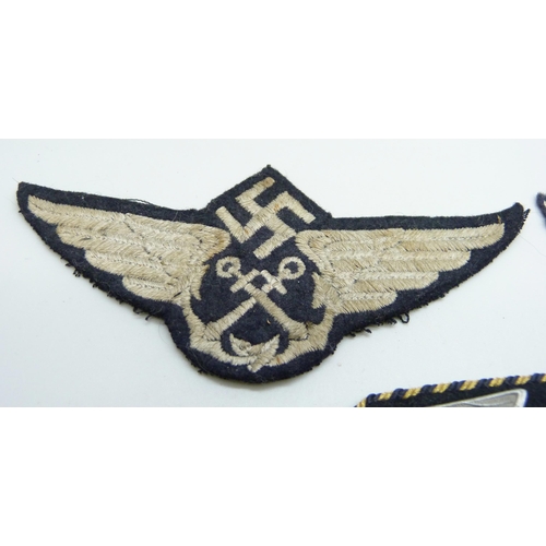 2083 - Three German WWII uniform patches, a German Reich Railway collar tab, a Luftwaffe patch and one othe... 