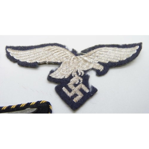 2083 - Three German WWII uniform patches, a German Reich Railway collar tab, a Luftwaffe patch and one othe... 